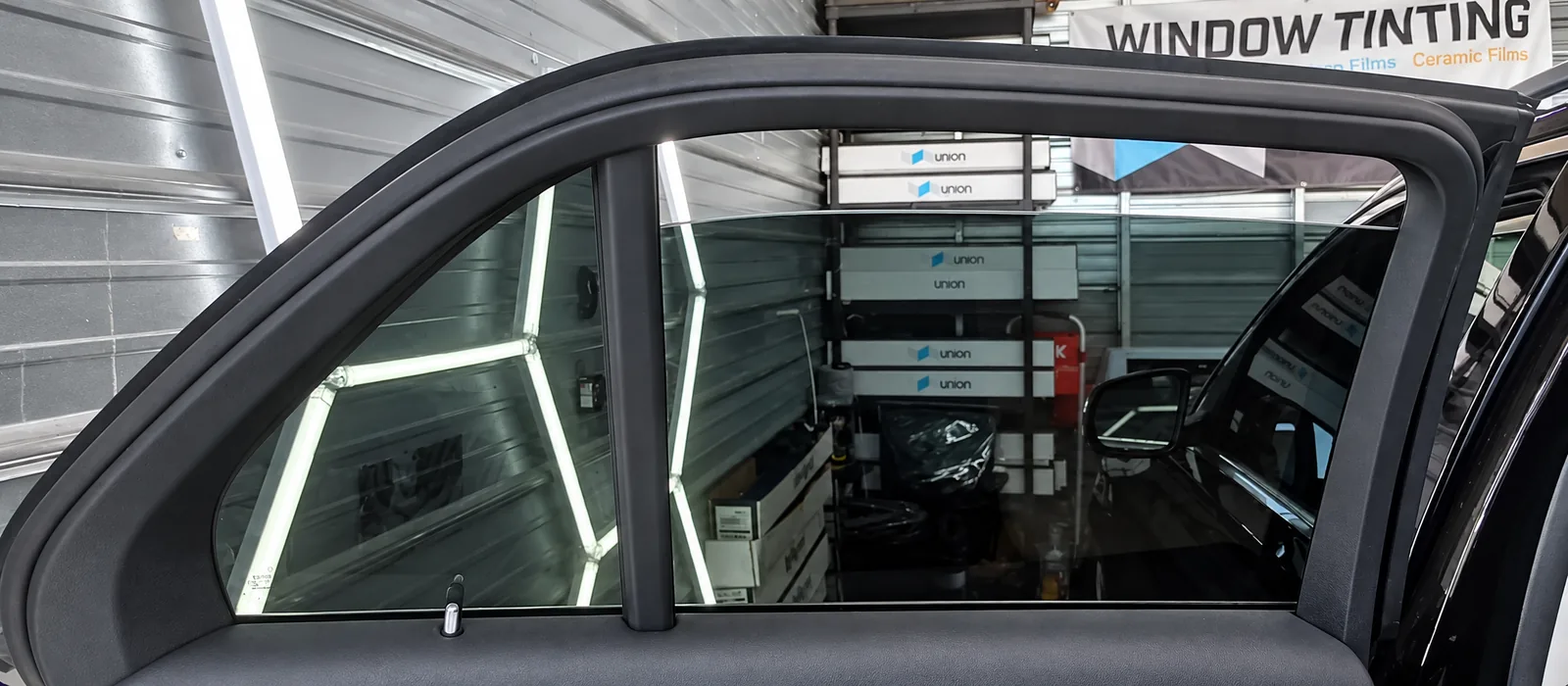 A freshly tinted rear door window in the bay, the glass lowered a little