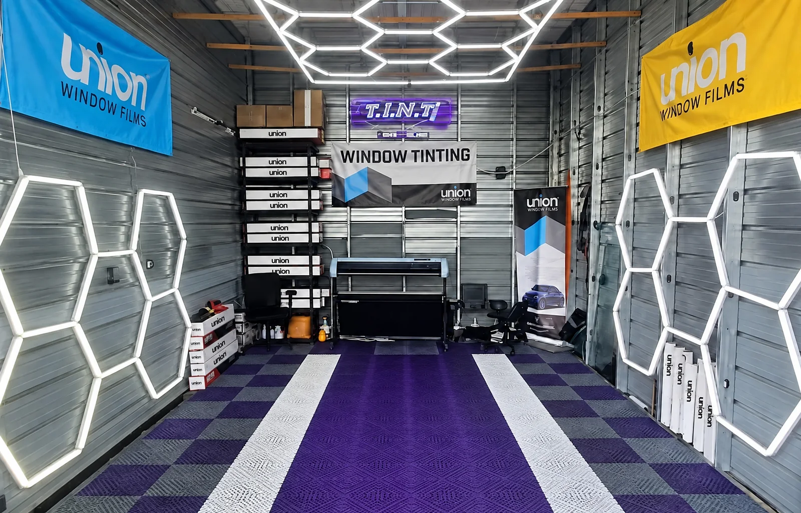 The T.I.N.T bay in Tacoma: the hexagon lights, the purple and white floor and the lit T.I.N.T sign