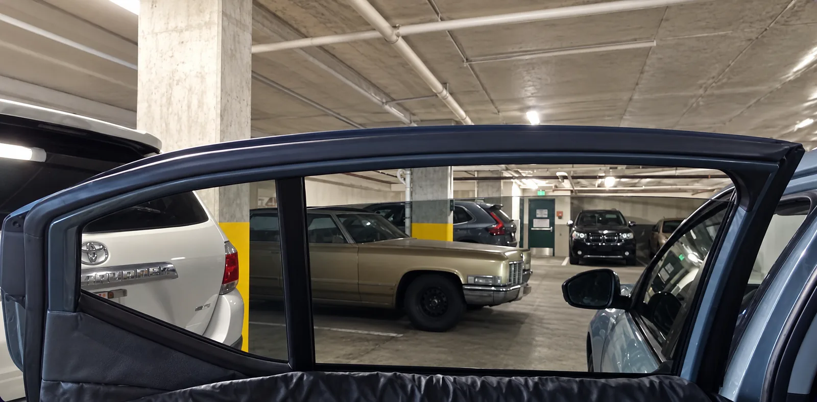 A rear door window tinted at a customer’s parking garage